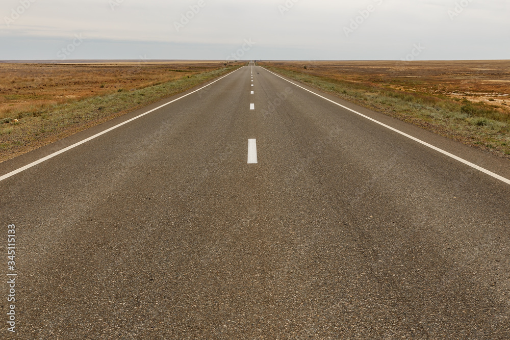 E38 highway in the Kazakhstan steppe. empty asphalt road E38 highway in the Kazakhstan steppe. empty asphalt road