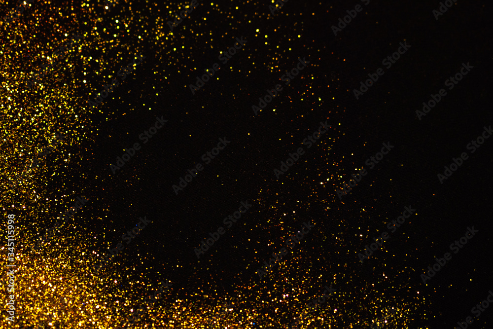 Abstract holiday background, gold Stardust on black.
