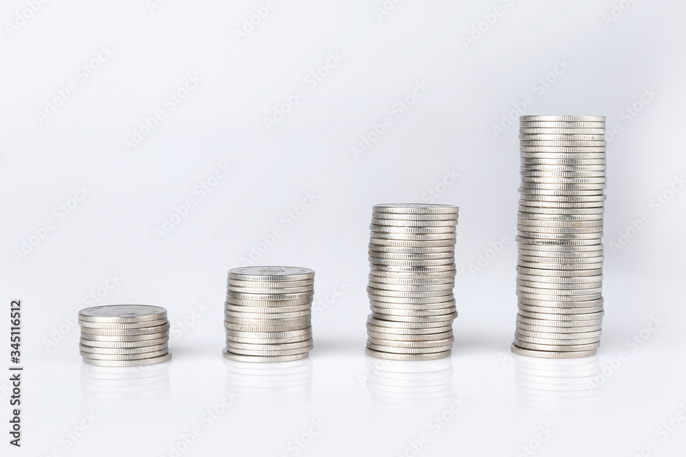Silver Thai baht coins stacked on a white background. Money saving concept Silver Thai baht coins stacked on a white background. Money saving concept