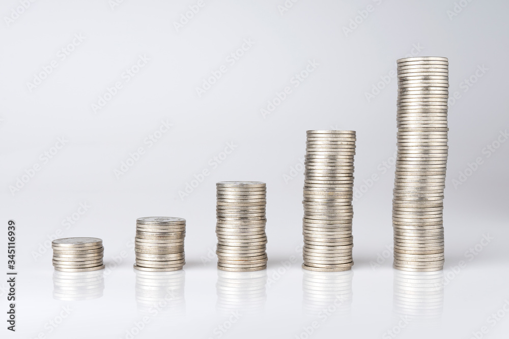 Silver Thai baht coins stacked on a white background. Money saving concept Silver Thai baht coins stacked on a white background. Money saving concept
