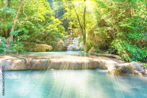 Fototapeta Naklejka Na Ścianę i Meble -  Tropical landscape with beautiful cascades of waterfall and green trees in wild jungle forest. Erawan National park, Kanchanaburi, Thailand