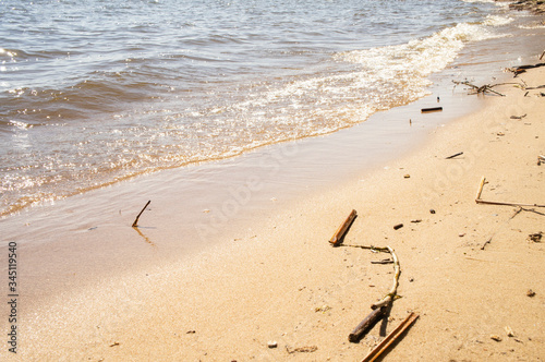 Golden sandy seashore with transparent wave