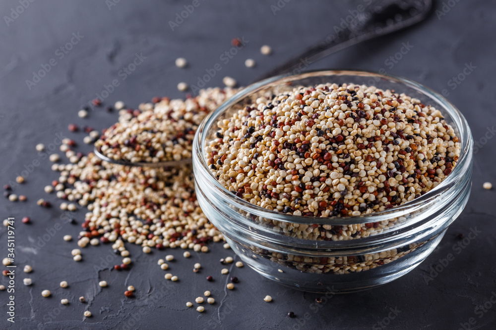 mix of quinoa grains on a dark stone background mix of quinoa grains on a dark stone background