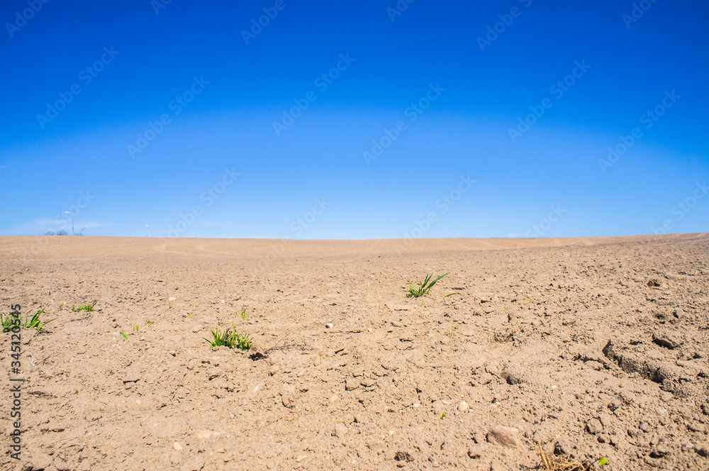 Sandy landscape in the Arabian desert and blue sky