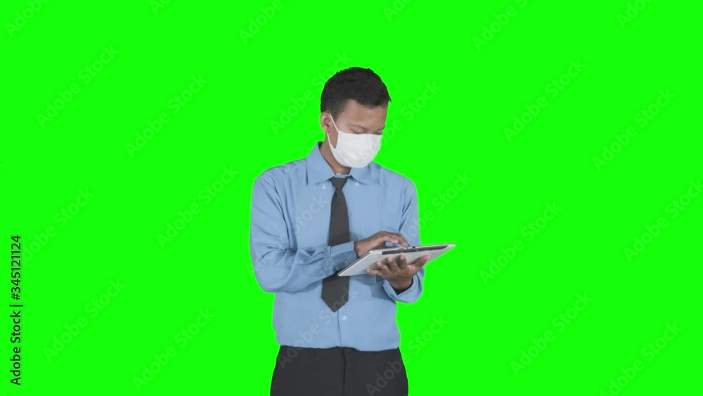 Businessman wear mask and using tablet while think Businessman wear mask and using tablet while think