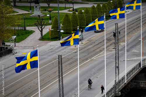 Norrkoping, Sweden  Swedish flags flying over the Drottninggatan bridge in downtown. photo