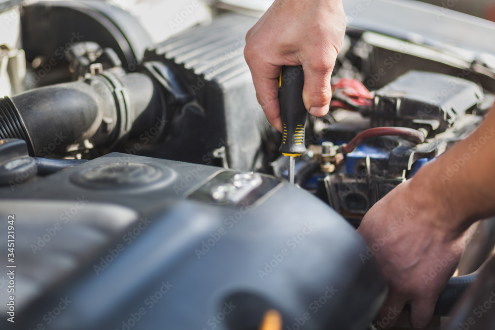 Man master repairs under the hood of the car Man master repairs under the hood of the car