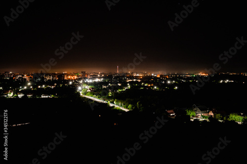 Aerial view of night town from Hill after sunset - modern city with spectacular nightscape panorama. aerial view  night city with night sky. natural summer night. horizontal