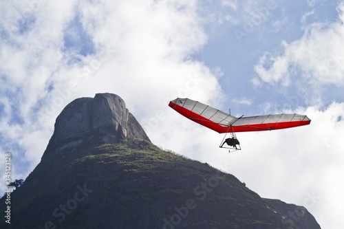 Amazing shot of human flying on a hang glider