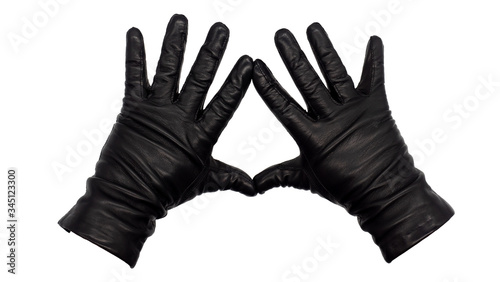 Hands wearing black leather gloves making a diamond or kite frame between thumb and index finger with fingers splayed, palms down. Female hand isolated, no skin