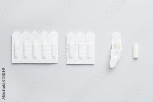 Hemorrhoidal suppositories on light background