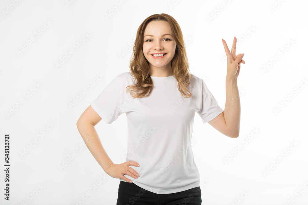 beautiful young woman in white t-shirt on a white background with hand gesture beautiful young woman in white t-shirt on a white background with hand gesture