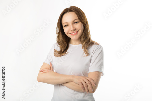 beautiful young woman in a white t-shirt on a white background
