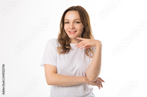 beautiful young woman in a white t-shirt on a white background © Alexandr