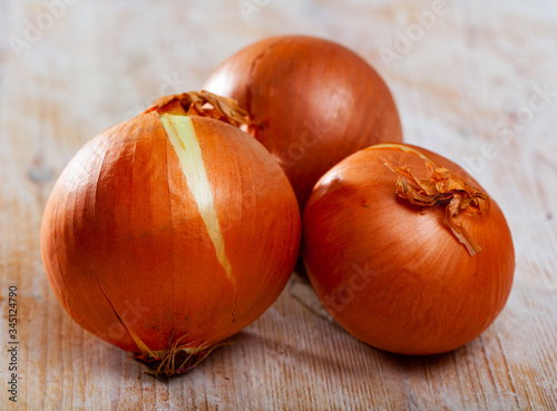 Onion bulbs on wooden background, nobody
