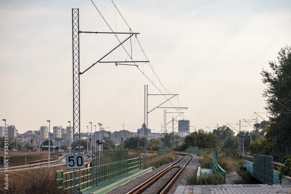 Platform in a modern train station on a suburban electrified line of the commuter railway network of Belgrade, Serbia. The cityscape can be seen in the background Platform in a modern train station on a suburban electrified line of the commuter railway network of Belgrade, Serbia. The cityscape can be seen in the background