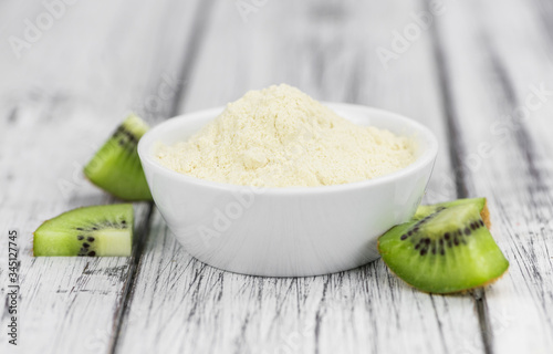 Bowl with fresh made Kiwi powder (selective focus)