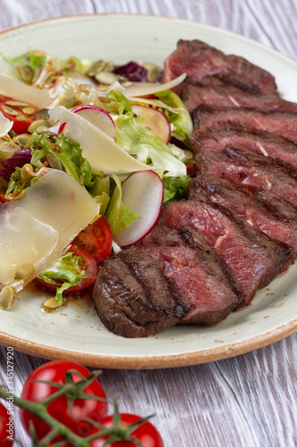 salad and sliced steak in a plate.