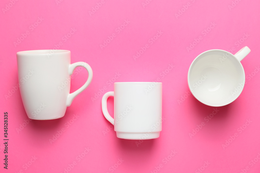 Blank cups on color background