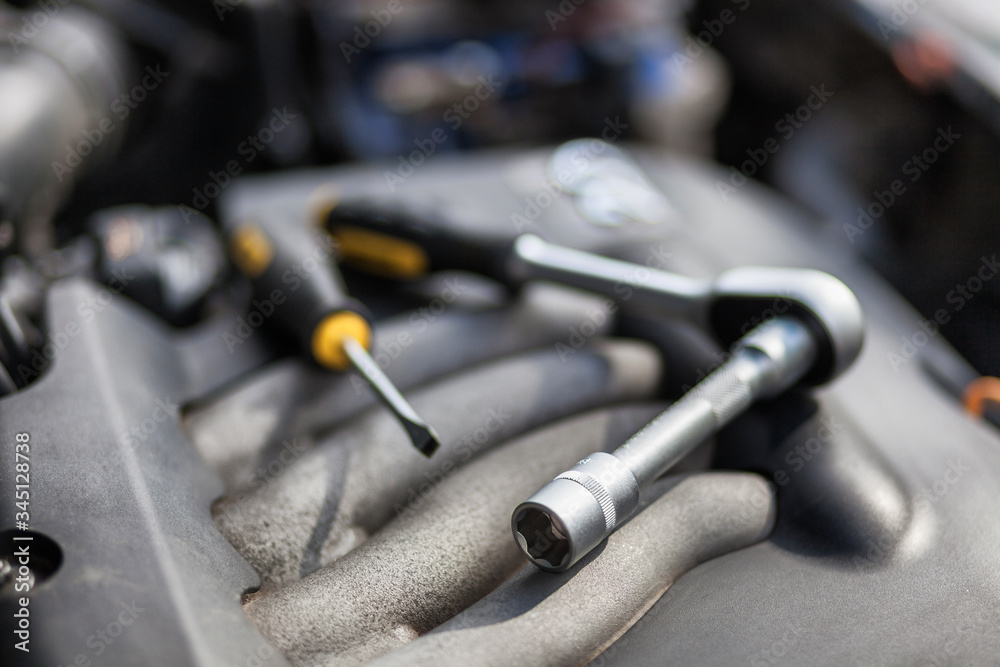 Man master repairs under the hood of the car Man master repairs under the hood of the car
