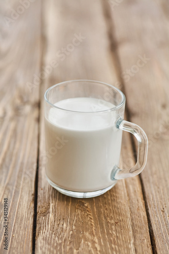 Glass milk on a wooden background. The concept of diet, weight loss.