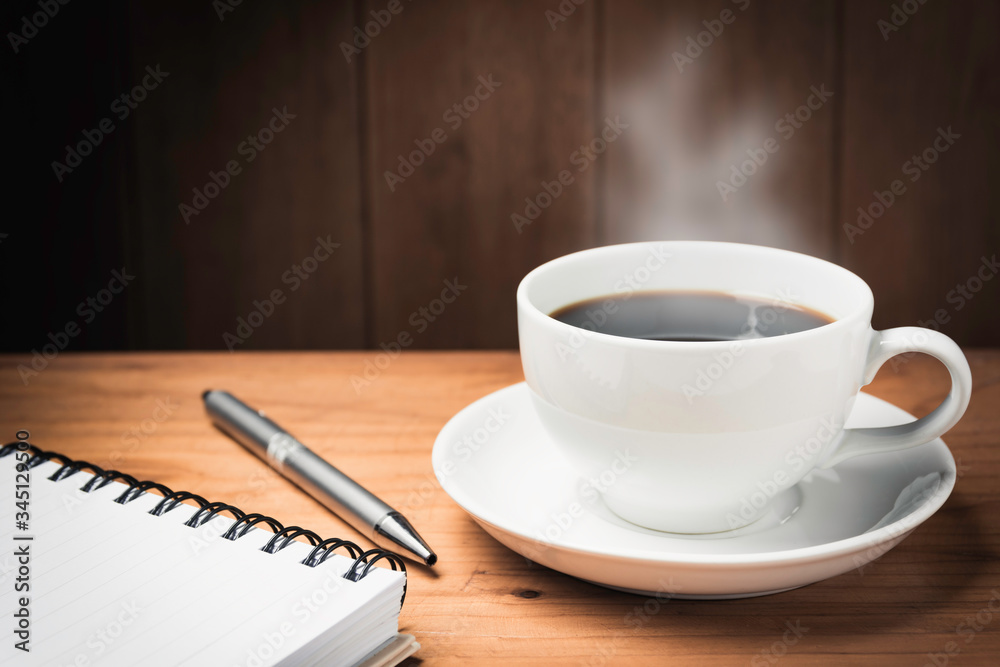 Wooden table desk with coffee. Workspace with note book, pen and coffee cup on wooden background with copy space. Wooden table desk with coffee. Workspace with note book, pen and coffee cup on wooden background with copy space.