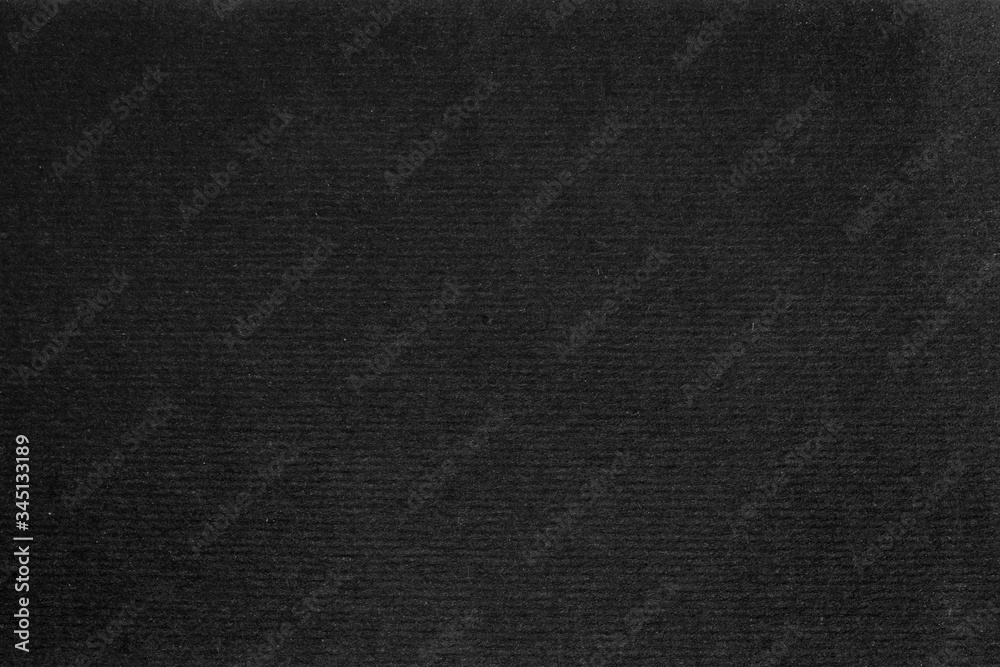 A dense industrial sheet of grey paper with a textured surface A dense industrial sheet of grey paper with a textured surface