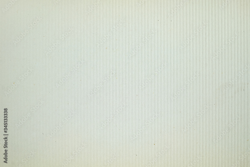 A dense industrial sheet of grey paper with a textured surface A dense industrial sheet of grey paper with a textured surface