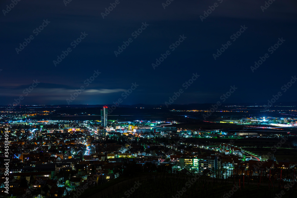 Germany, Dark night atmosphere over fellbach city skyline, aerial view above the houses by night