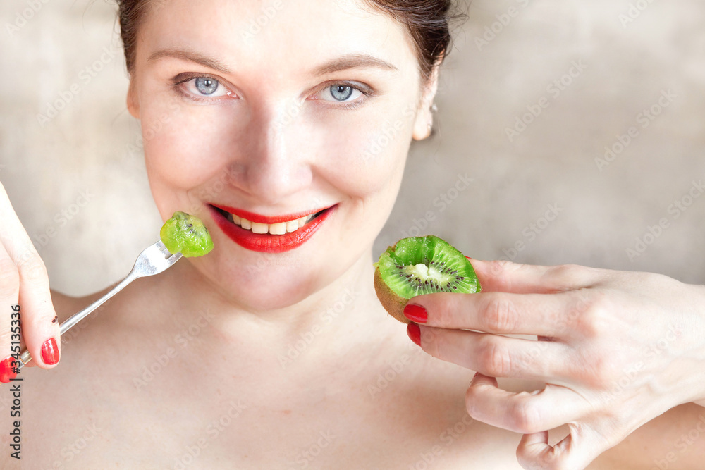 girl with red lipstick eats a ripe kiwi close up girl with red lipstick eats a ripe kiwi close up