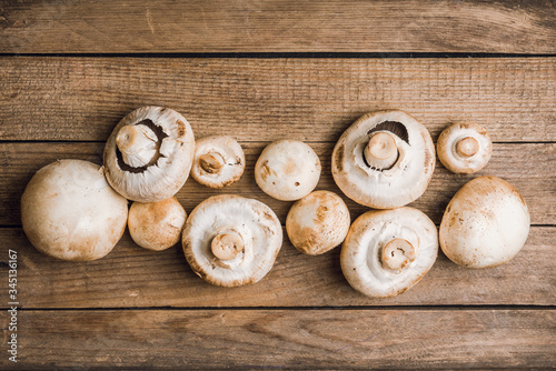Freshly harvested mushrooms on the rustic wooden background. Selective focus. Shallow depth of field.