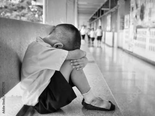 A Thai elementary school student was sitting alone with sadness in school.