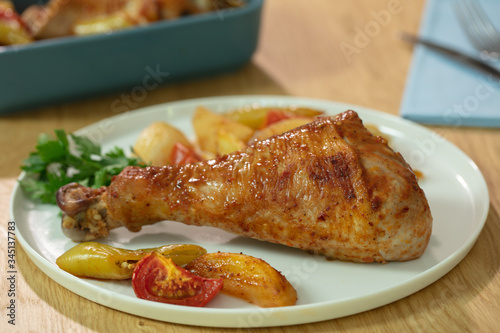 Roasted chicken legs with potato and tomatoes