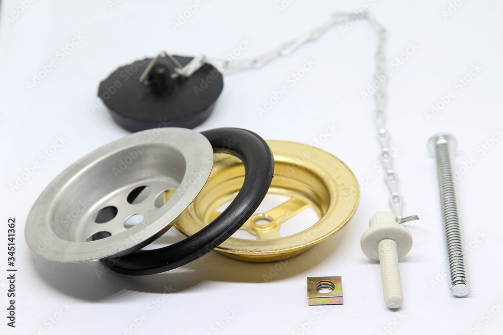 Naklejka premium Bath sink plughole set and rubber plug with chain on white background.