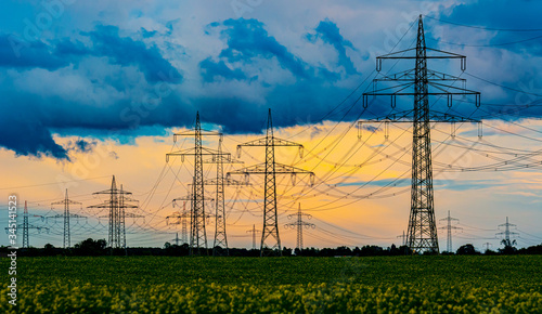 High voltage Power Pylons and Power lines in the field photo