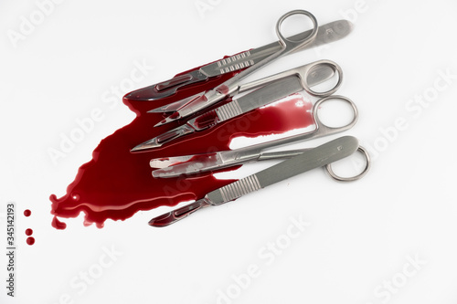 Surgical instrument tools with blood, scalpel with blade, forceps tweezers, scissors for surgeon in surgery