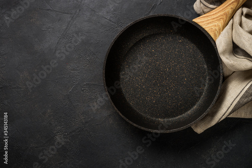 Frying pan or skillet on black table.
