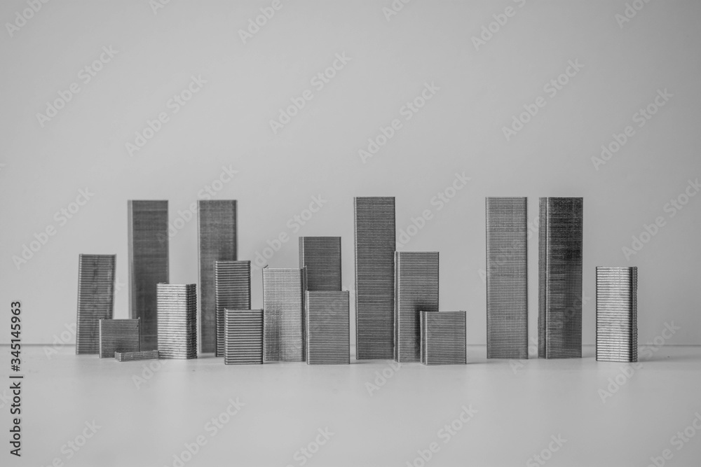 A fake cityscape styled from staplers designed to look like skyscrapers and city block towers against a white background