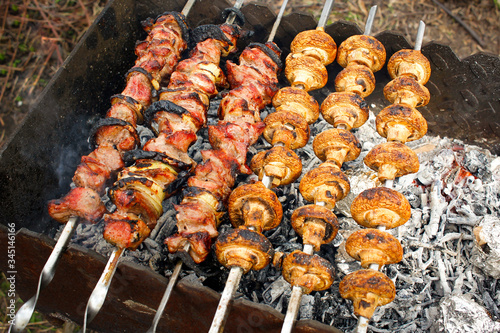Grilled pork kebab and mushrooms on the grill