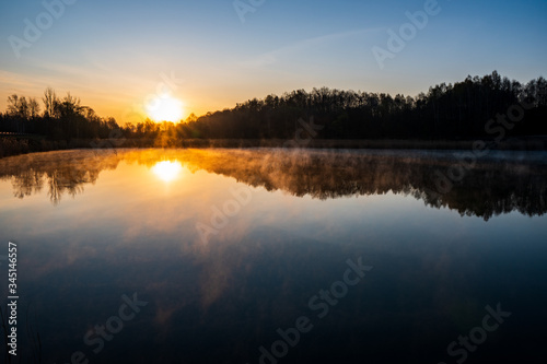 sunrise over the lake with tree reflection and beautiful fog © Martin