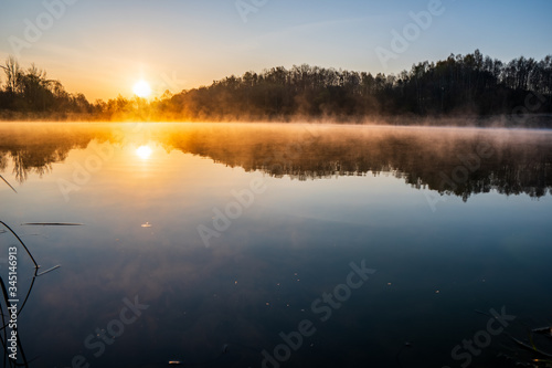 sunrise over the lake with tree reflection and beautiful fog © Martin