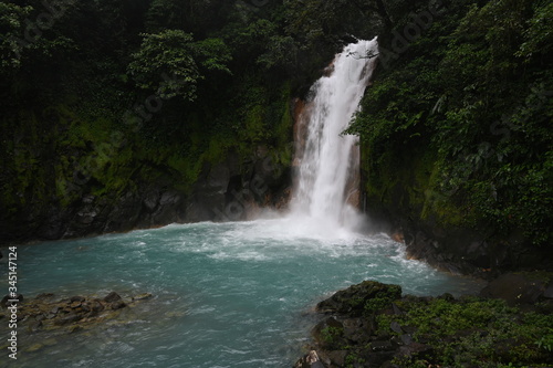 Costa Rica Waterfall in Summer into Blue Water © Evan
