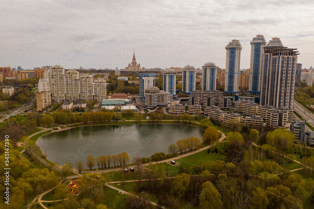 Obraz premium residential buildings around the city lake removed from the drone