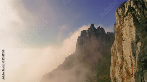 Canyon of the Crimea-a popular place, Cape Fiolent, Sevastopol, Balaklava, Crimea republics, cross on the rocks, Peninsula, fog, rocks in the clouds, prongs of stone, drone flight over the clouds, smo