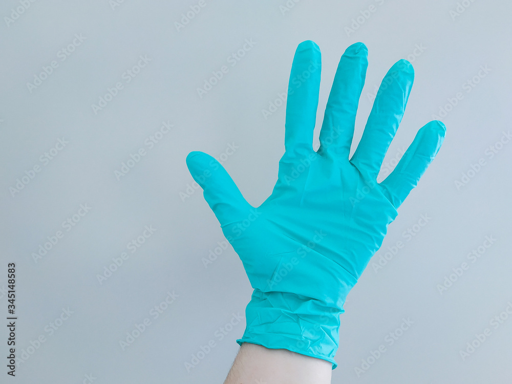 DiDisposable blue medical gloves on hands DiDisposable blue medical gloves on hands