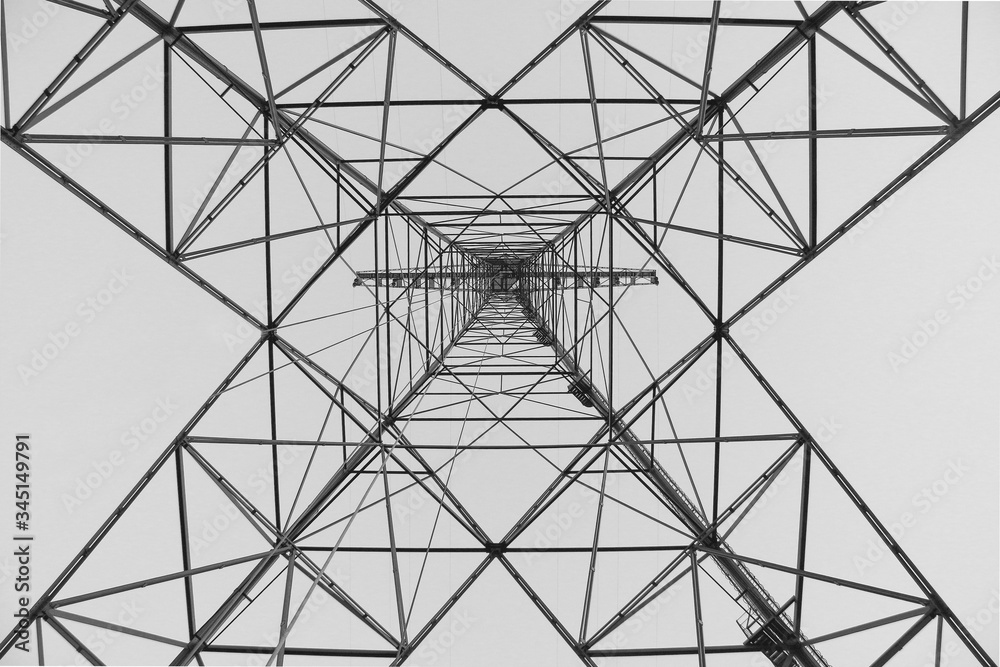 Abstract Detail of electricity pylon in black and white, high voltage electric pillar from below