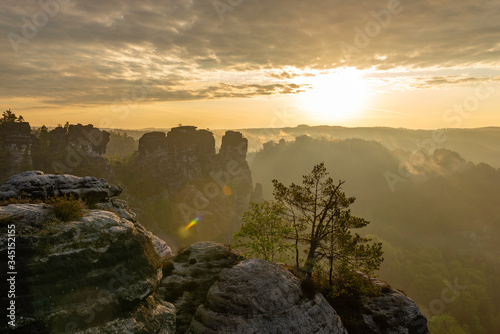 a beautiful view down in the tales from a viewpoint on the top of the Bastei in saxon switzerland, Germany