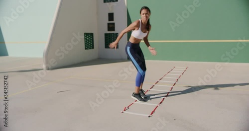 Female doing agility drills outside