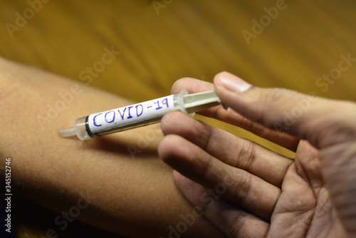 corona antivirus vaccines inject in boy hand with blur background, stay home stay safe 