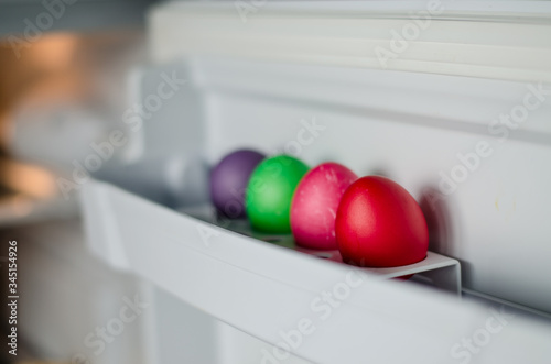 Easter eggs of different colors are in the refrigerator door